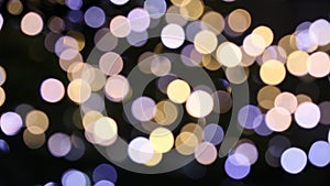 Christmas holiday colorful lights bokeh background. Changing blue and purple, colors isolated on black.