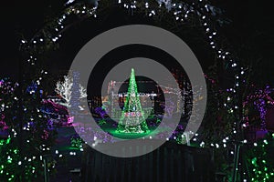 Christmas holiday colorful outdoor framed tree in green lights