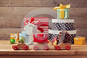 Christmas holiday concept with gift boxes on toy cars