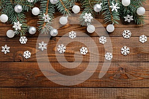 Christmas holiday decoration and fir tree branches on wooden table. Xmas background. Flat lay, top view