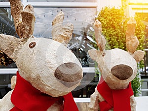 Christmas holiday decorations and reindeer in front of reflect glass with light. home decorate for christmas. happy christmas