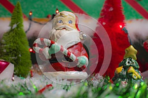 Christmas holiday decorations scene Santa close up and red and green tree