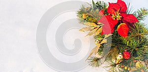 Christmas holiday faux poinsettia pine wreath with white copyspace.