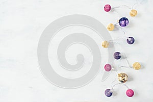 Christmas holiday festive theme with golden pink violet ball LED garland and gold and purple Christmas ornament