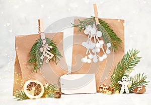 Christmas holiday gift bags for suprise, fir branches, gingerbread man, elk, snow covered berries and nuts, blank tag