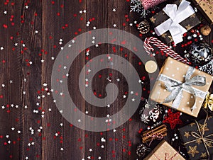 Christmas holiday gift box on decorated festive table with pine cones candy cane candle ball