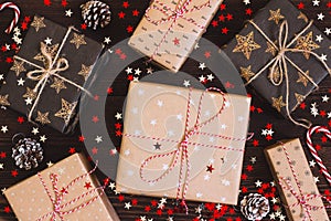 Christmas holiday gift box on decorated festive table with pine cones and sparkle stars