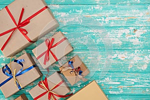Christmas holiday gift shopping background. view from above with copy space. craft paper present boxes tied from rope on blue