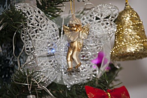 Christmas holiday, golden ring and butterfly in xmass tree, angel