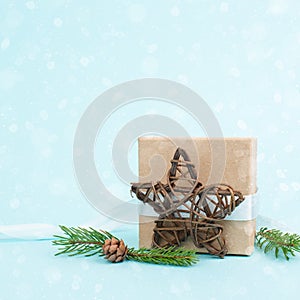 Christmas holiday greeting card with little gift box, pine cones and fir branches, blue background