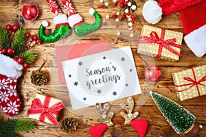 Christmas holiday greeting card or newsletter mock up template with decorations and ornaments on wooden table