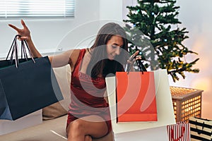 Christmas holiday happy woman with shopping bags at home. New Year