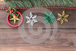 Christmas and Holiday Season Concept. Top view of xmas ornament accessories and mockup tree on old wooden plank with copy space