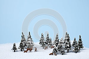Christmas holiday theme with reindeer and winter trees on the snow
