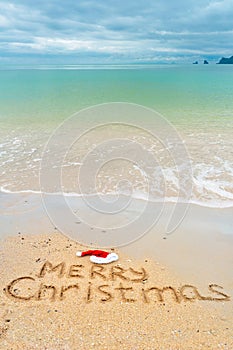 Christmas holiday vacation concept, Merry Christmas written on tropical beach sand