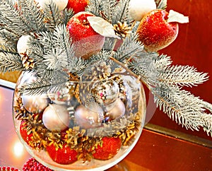 Christmas holidays composition with red apples, silver balls, andglass vase