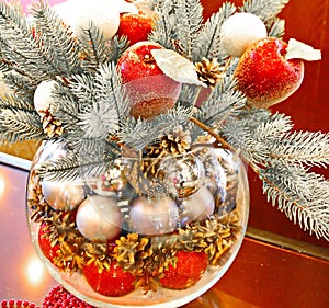 Christmas holidays composition with red apples, silver balls, andglass vase