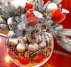 Christmas holidays composition with red apples, silver balls, andglass vase