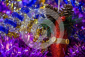 Christmas holidays composition with red gliter cone in colored tinsel - close-up with selective focus