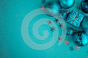 Christmas holidays composition, top view blue-aquamarine Christmas decorations on a green-blue background with copy