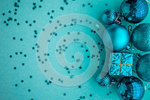 Christmas holidays composition, top view blue-aquamarine Christmas decorations on a green-blue background with copy