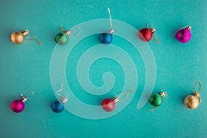 Christmas holidays composition, top view colored christmas decorations on green-blue-aquamarine background with copy