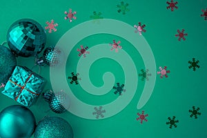 Christmas holidays composition, top view colored green and aquamarine Christmas decorations on green background with