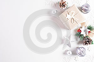 Christmas holidays composition Top view of gift box with Christmas tree decoration and red berries on white background with copy