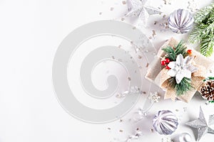 Christmas holidays composition Top view of gift box with Christmas tree decoration and red berries on white background with copy