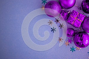 Christmas holidays composition, top view pink-purple-violet Christmas decorations on white-blue background with copy