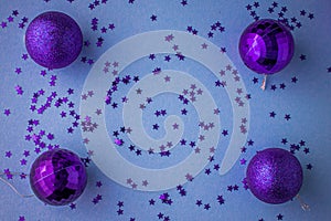 Christmas holidays composition, top view pink-purple-violet Christmas decorations on white-blue background with copy