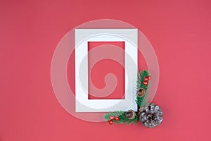 Christmas holidays composition, top view of red Christmas decorations and picture frame on red background with copy space for text
