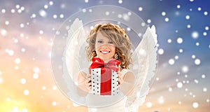 Teenage girl with angel wings and christmas gift