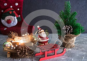 Merry christmas and a happy new year. a Santa Claus toy, a burning candle and a sleigh. Christmas Holidays. set of Christmas ornam