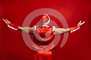 Christmas holidays. strong santa claus wearing hat. Young muscular man. red background.