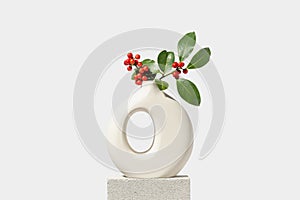 Christmas holly with red berries in white vase. Winter natural decoration.
