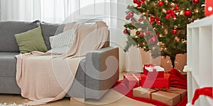 Christmas Home Interior. Stylish Living Room With Christmas Tree, Sofa and Gift Boxes With Presents