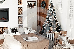 Christmas home interior with tree and fireplace. living room in country house decorated with lights and candles