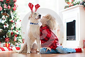 Christmas at home. Kids and dog under Xmas tree