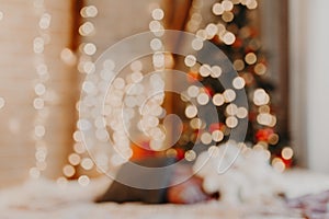 Christmas home room with tree and festive bokeh lighting, blurred holiday background photo