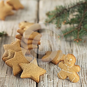 Christmas homemade gingerbread cookies, gingerbread man. On a wooden vintage background, near the branches of spruce. Close-up