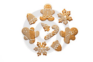 Christmas homemade gingerbread cookies of a man, snowflake, bell, star and tree with icing isolated on white background