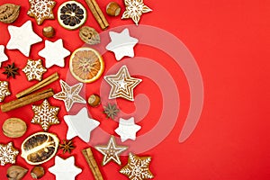 christmas homemade gingerbread cookies and spices over red background