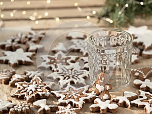 Christmas homemade gingerbread cookies on a wooden table, glass cup for a drink. Close-up. homemade baking