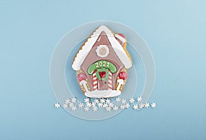 Christmas homemade gingerbread house cookies on a blue background