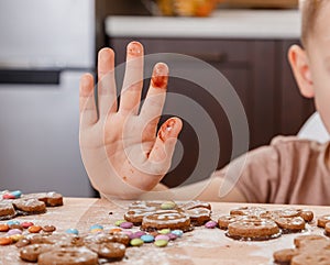 Christmas homemade gingerbread man cookies. Gingerbread Girls and Boys Dough on Wooden Background. Children`s hand and