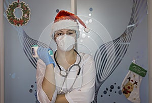 Christmas in the hospital: nurse doctor wearing Santa hat with electronic thermometer