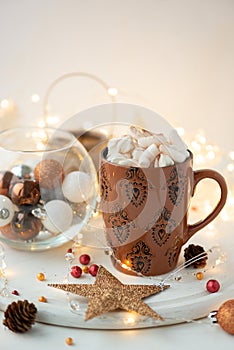 Christmas hot chocolate with marshmallow and gingerbread cookies on white wooden table. Traditional hot drink at Christmas