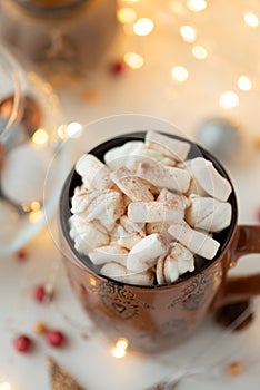 Christmas hot chocolate with marshmallow and gingerbread cookies on white wooden table. Traditional hot drink at Christmas