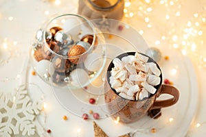 Christmas hot chocolate with marshmallow and gingerbread cookies on white wooden table. Traditional hot drink at Christmas